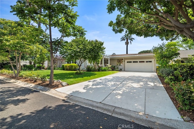 13782 Gershon Pl, North Tustin, CA 92705 - view of property hidden behind natural elements with an attached garage, a front lawn, concrete driveway, and stucco siding
