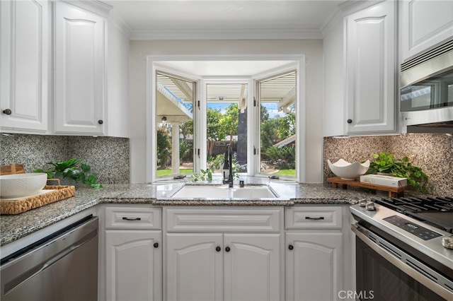 13782 Gershon Pl, North Tustin, CA 92705 - kitchen featuring stainless steel appliances, white cabinets, decorative backsplash, light stone counters, and crown molding
