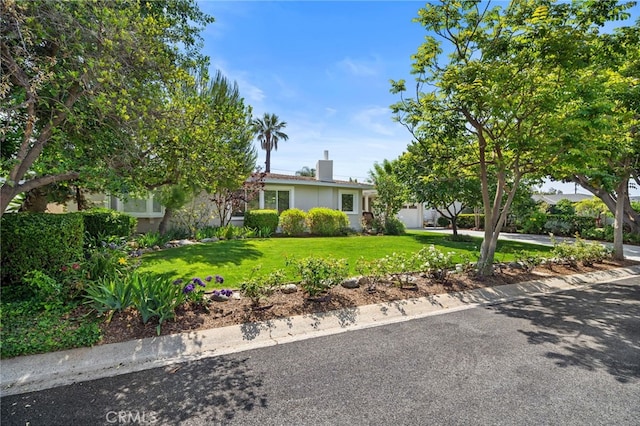 13782 Gershon Pl, North Tustin, CA 92705 - view of front of house featuring a front yard, a chimney, and stucco siding