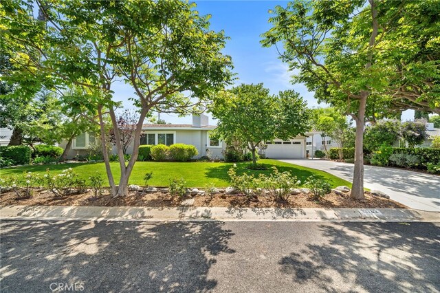 13782 Gershon Pl, North Tustin, CA 92705 - view of front of house featuring concrete driveway, a front lawn, an attached garage, and stucco siding