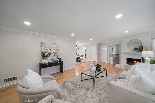 13782 Gershon Pl, North Tustin, CA 92705 - living area with a fireplace, recessed lighting, ornamental molding, wood finished floors, and a ceiling fan
