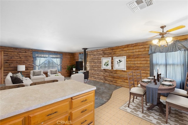 38579 Payne Way, Caliente, CA 93518 - kitchen with rustic walls, ceiling fan, light countertops, a wood stove, and open floor plan