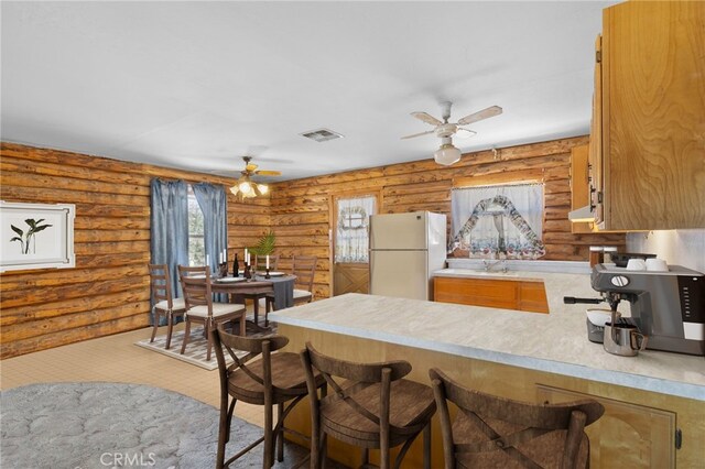 38579 Payne Way, Caliente, CA 93518 - kitchen with freestanding refrigerator, ceiling fan, a peninsula, light countertops, and a breakfast bar