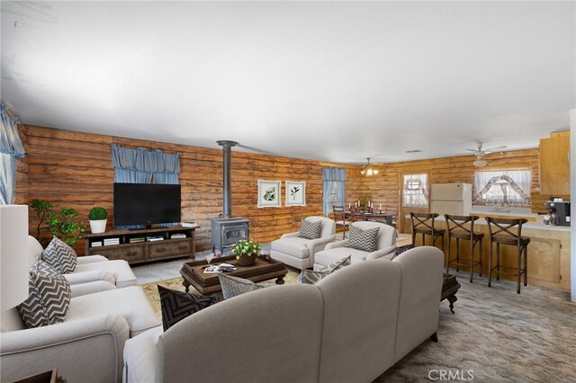 38579 Payne Way, Caliente, CA 93518 - carpeted living area with log walls, a wood stove, and a ceiling fan