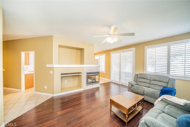 543 Northwood Ave, Banning, CA 92220 - living room featuring a tile fireplace, ceiling fan, wood finished floors, and baseboards