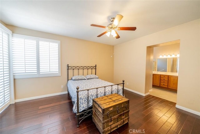 543 Northwood Ave, Banning, CA 92220 - bedroom with dark wood-style flooring, baseboards, connected bathroom, and a ceiling fan