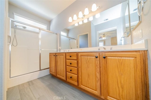 543 Northwood Ave, Banning, CA 92220 - full bathroom with a shower stall, double vanity, and ceiling fan