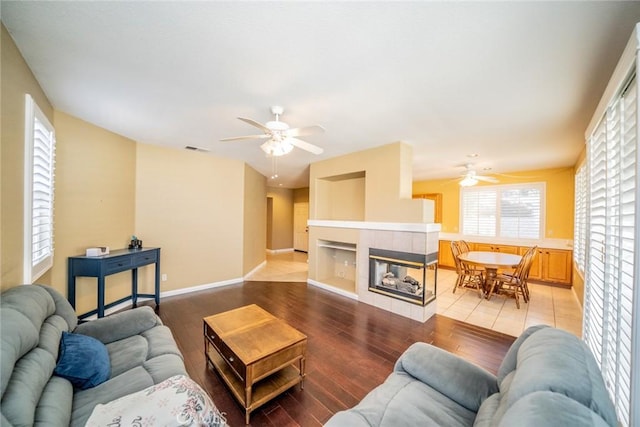 543 Northwood Ave, Banning, CA 92220 - living area featuring a ceiling fan, light wood-type flooring, and a tile fireplace