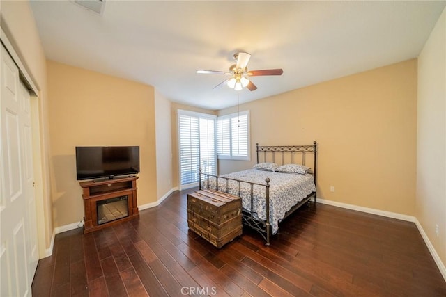543 Northwood Ave, Banning, CA 92220 - bedroom with dark wood finished floors, baseboards, a closet, and a ceiling fan