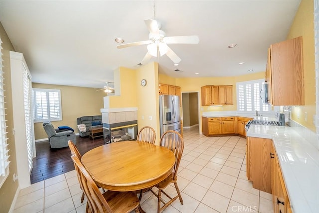 543 Northwood Ave, Banning, CA 92220 - dining room with ceiling fan, light tile patterned floors, a tile fireplace, recessed lighting, and baseboards