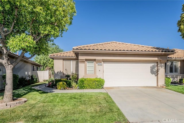 543 Northwood Ave, Banning, CA 92220 - mediterranean / spanish house featuring a tiled roof, stucco siding, an attached garage, and driveway