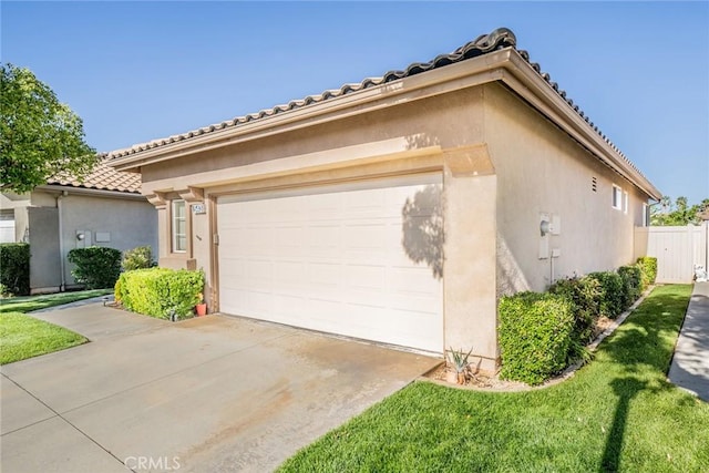 543 Northwood Ave, Banning, CA 92220 - mediterranean / spanish home with stucco siding, a tiled roof, driveway, a garage, and a front yard
