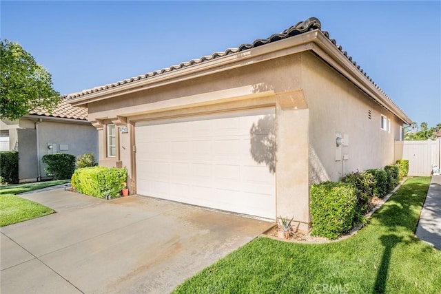 543 Northwood Ave, Banning, CA 92220 - mediterranean / spanish home featuring stucco siding, a tiled roof, driveway, and an attached garage