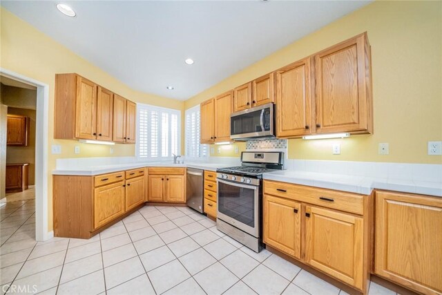 543 Northwood Ave, Banning, CA 92220 - kitchen featuring stainless steel appliances, light tile patterned floors, light countertops, recessed lighting, and light brown cabinets