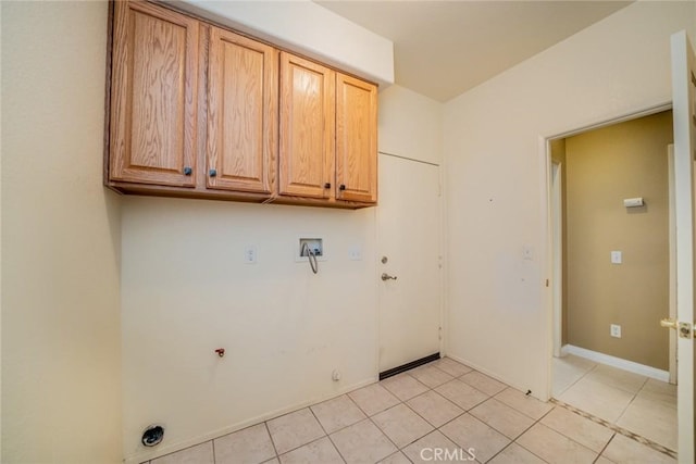 543 Northwood Ave, Banning, CA 92220 - laundry area featuring cabinet space, hookup for a gas dryer, light tile patterned floors, hookup for a washing machine, and baseboards