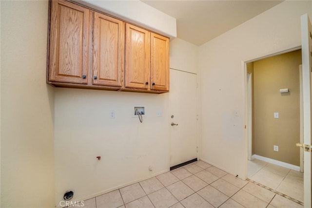 543 Northwood Ave, Banning, CA 92220 - laundry room featuring cabinet space, hookup for a gas dryer, light tile patterned floors, and hookup for a washing machine