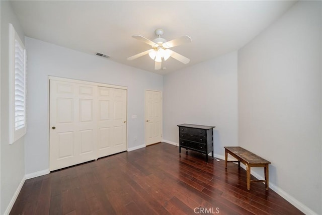 543 Northwood Ave, Banning, CA 92220 - unfurnished bedroom with wood-type flooring, baseboards, a closet, and ceiling fan