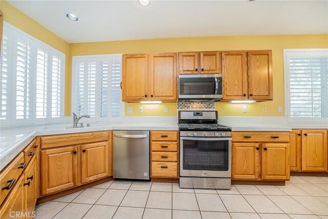 543 Northwood Ave, Banning, CA 92220 - kitchen featuring appliances with stainless steel finishes, light countertops, light tile patterned floors, and recessed lighting