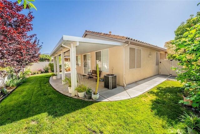 543 Northwood Ave, Banning, CA 92220 - rear view of house with a patio area, stucco siding, a tile roof, and a gate