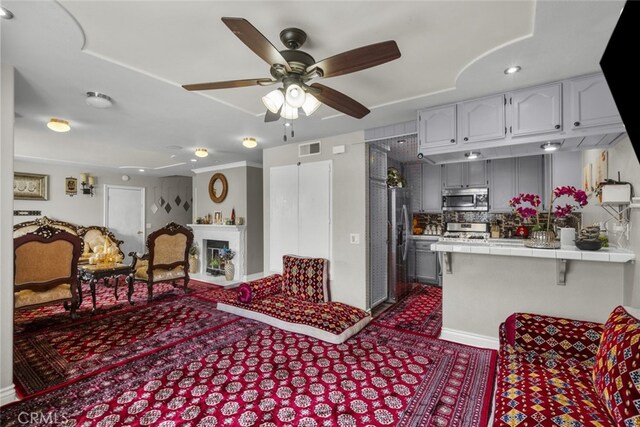 2346 Royal Ave Unit 9, Simi Valley, CA 93065 - kitchen featuring appliances with stainless steel finishes, tile countertops, ceiling fan, backsplash, and dark colored carpet