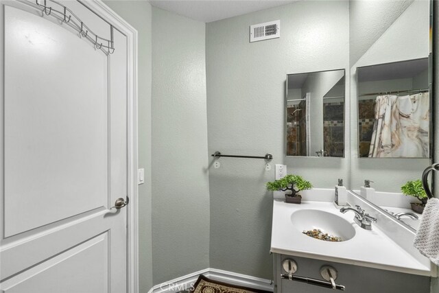 2346 Royal Ave Unit 9, Simi Valley, CA 93065 - bathroom featuring vanity, a textured wall, and baseboards