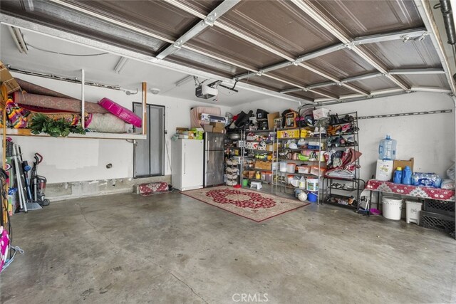 2346 Royal Ave Unit 9, Simi Valley, CA 93065 - garage with a garage door opener and freestanding refrigerator