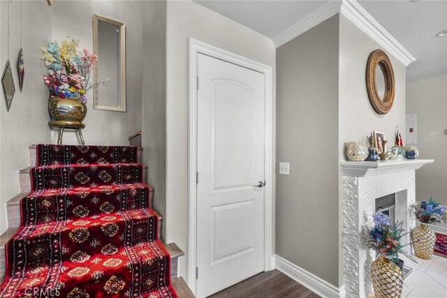2346 Royal Ave Unit 9, Simi Valley, CA 93065 - staircase featuring crown molding, baseboards, a fireplace, and wood finished floors