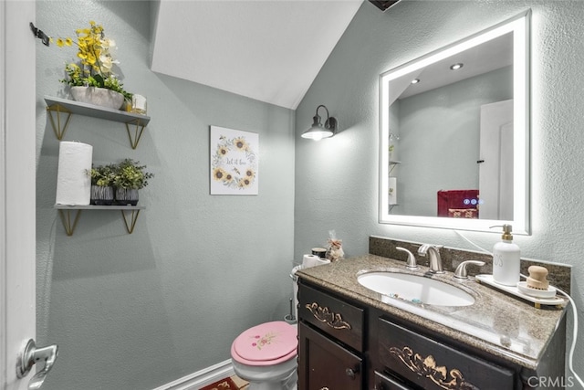 2346 Royal Ave Unit 9, Simi Valley, CA 93065 - half bath with toilet, vanity, a textured wall, and lofted ceiling