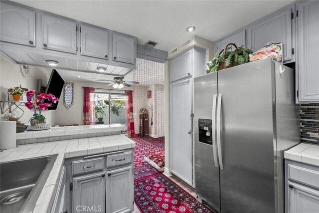 2346 Royal Ave Unit 9, Simi Valley, CA 93065 - kitchen featuring stainless steel fridge, tile countertops, a sink, tasteful backsplash, and ceiling fan