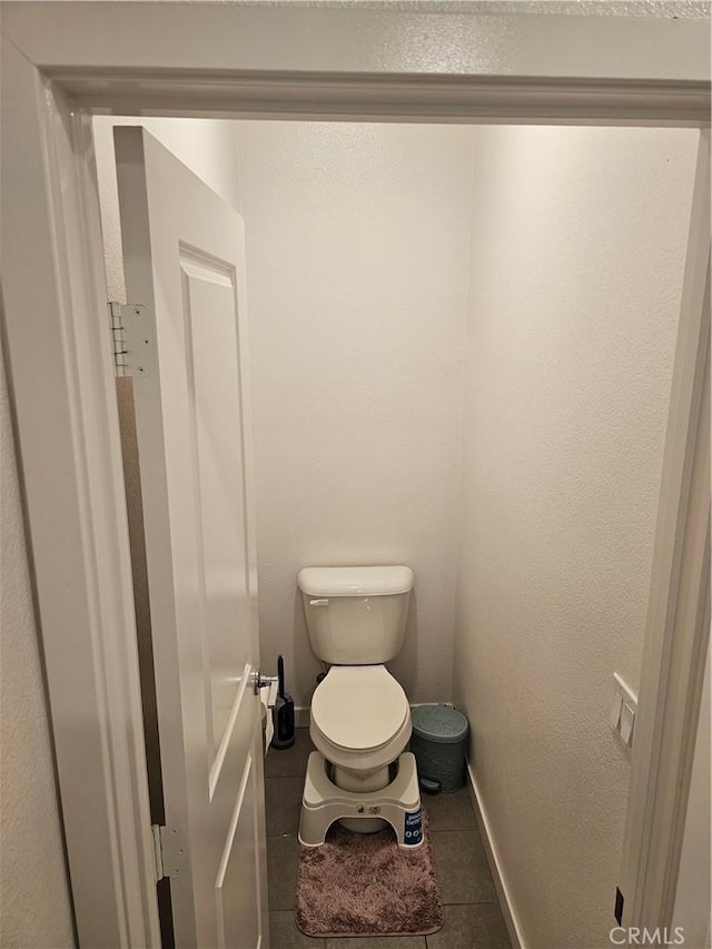 10402 Harlow Cir Unit 41, San Diego, CA 92108 - bathroom with baseboards, toilet, and tile patterned floors