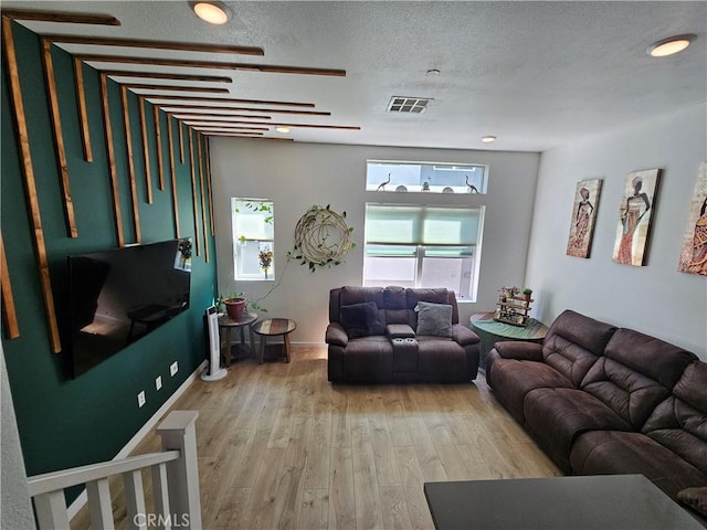10402 Harlow Cir Unit 41, San Diego, CA 92108 - living room featuring light wood-type flooring, a textured ceiling, and baseboards