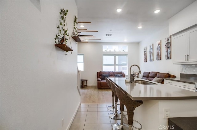 10402 Harlow Cir Unit 41, San Diego, CA 92108 - kitchen with open floor plan, light tile patterned floors, a breakfast bar, dark countertops, and recessed lighting