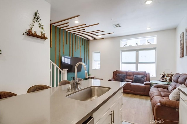 10402 Harlow Cir Unit 41, San Diego, CA 92108 - kitchen featuring open floor plan, white cabinets, recessed lighting, healthy amount of natural light, and light wood-style flooring