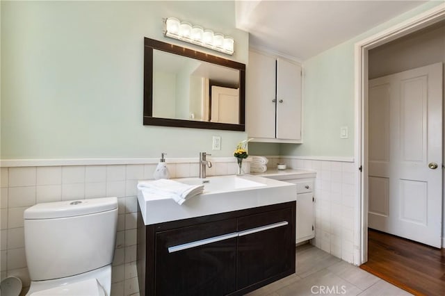 5023 Stern Ave, Sherman Oaks, CA 91423 - bathroom with tile walls, vanity, toilet, wainscoting, and tile patterned floors
