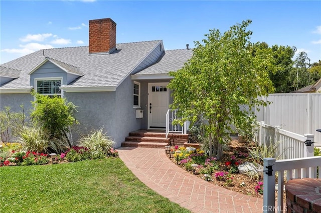 5023 Stern Ave, Sherman Oaks, CA 91423 - view of front of house featuring a shingled roof, a chimney, and stucco siding
