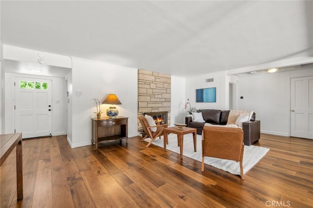 5023 Stern Ave, Sherman Oaks, CA 91423 - living room featuring wood-type flooring, a stone fireplace, and baseboards
