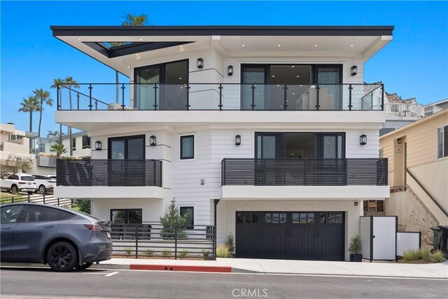 2141 Circle Dr, Hermosa Beach, CA 90254 - view of front of home with a balcony, stucco siding, and a garage