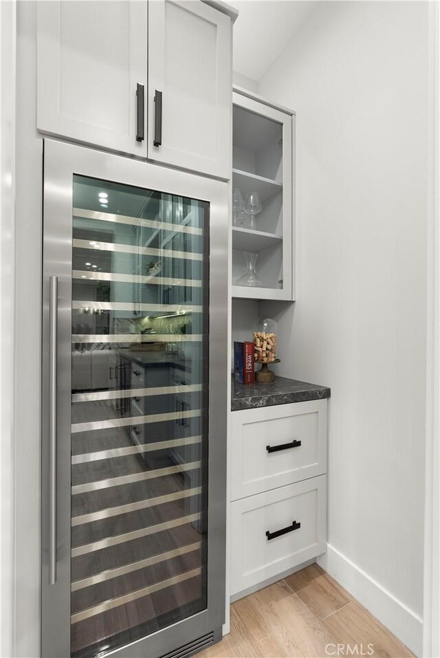 2141 Circle Dr, Hermosa Beach, CA 90254 - bar featuring wine cooler, light wood-style floors, and baseboards