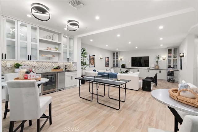 2141 Circle Dr, Hermosa Beach, CA 90254 - living room with beverage cooler, bar with sink, light wood-style floors, and recessed lighting