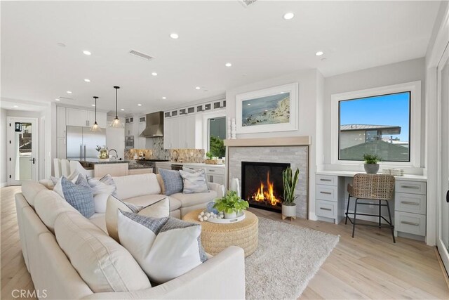 2141 Circle Dr, Hermosa Beach, CA 90254 - living room with light wood finished floors, recessed lighting, and a warm lit fireplace