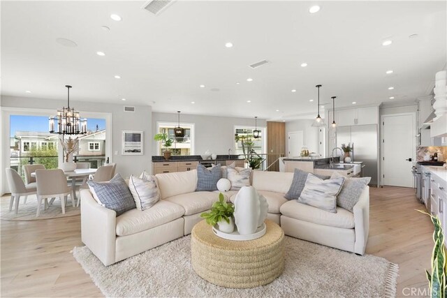 2141 Circle Dr, Hermosa Beach, CA 90254 - living room with recessed lighting, light wood-style floors, and a chandelier
