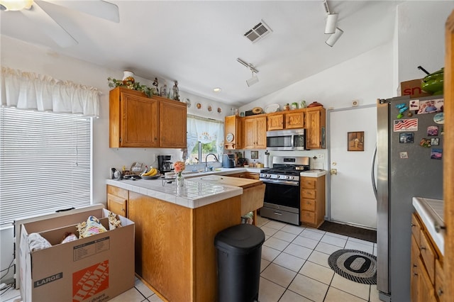 32725 Trailwood Ct, Wildomar, CA 92595 - kitchen featuring stainless steel appliances, track lighting, a peninsula, lofted ceiling, and light tile patterned floors