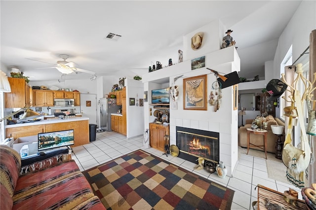32725 Trailwood Ct, Wildomar, CA 92595 - living room featuring light tile patterned floors, a tiled fireplace, and ceiling fan