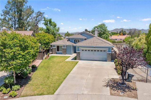 32725 Trailwood Ct, Wildomar, CA 92595 - view of front of house with a tile roof, an attached garage, stone siding, concrete driveway, and a mountain view