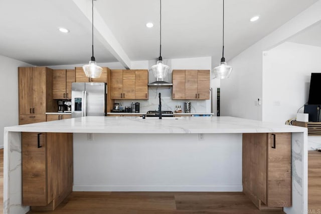 6252 Lake Albano Ave, San Diego, CA 92119 - kitchen with stainless steel fridge, wood finished floors, a large island, brown cabinetry, and baseboards
