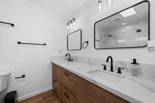 6252 Lake Albano Ave, San Diego, CA 92119 - full bathroom featuring toilet, a marble finish shower, double vanity, wood finished floors, and baseboards