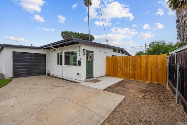 6252 Lake Albano Ave, San Diego, CA 92119 - view of front of home featuring a garage, driveway, and stucco siding