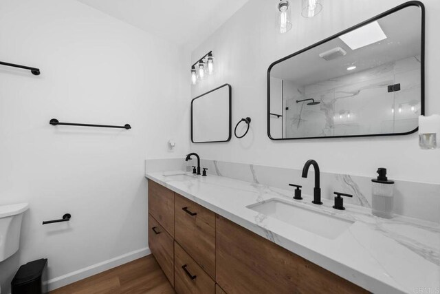 6252 Lake Albano Ave, San Diego, CA 92119 - bathroom with a marble finish shower, double vanity, and wood finished floors