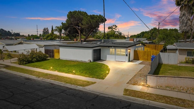 6252 Lake Albano Ave, San Diego, CA 92119 - view of front of home featuring concrete driveway, solar panels, an attached garage, and stucco siding