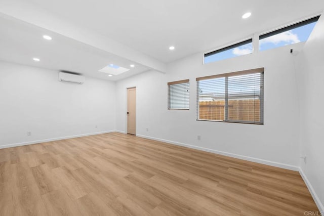 6252 Lake Albano Ave, San Diego, CA 92119 - spare room featuring an AC wall unit, recessed lighting, and light wood-type flooring